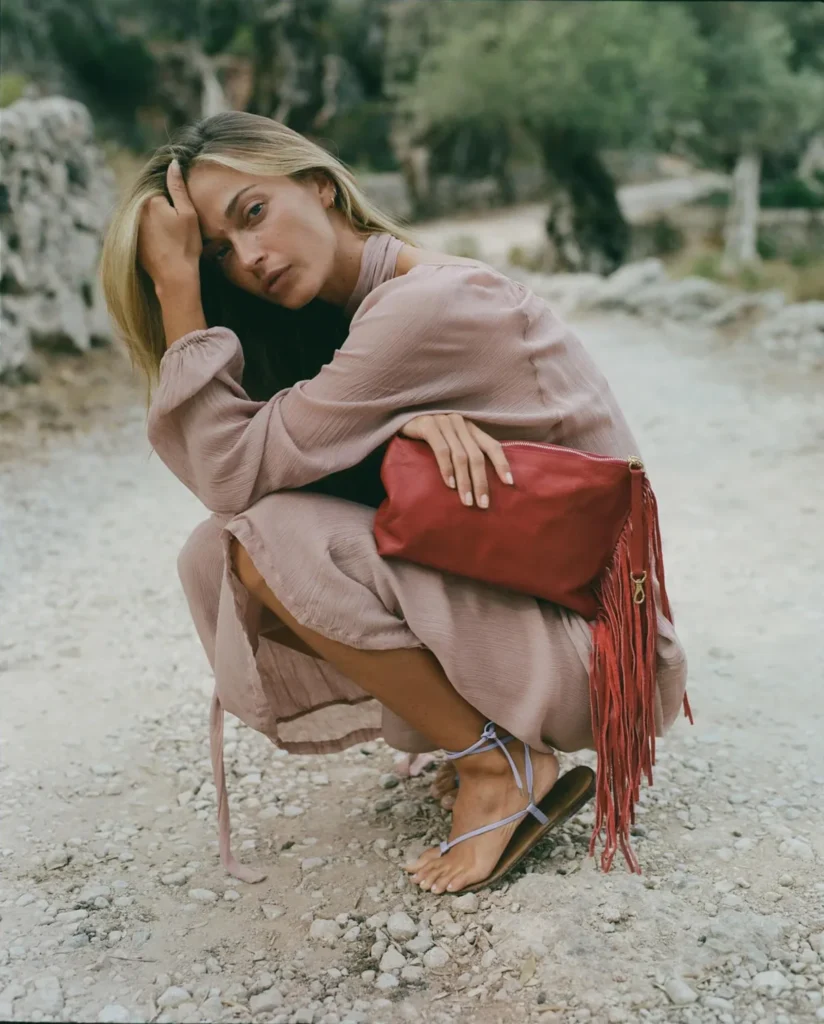 Model holding the Selva Fringe red top handle bag by YAO Heritage